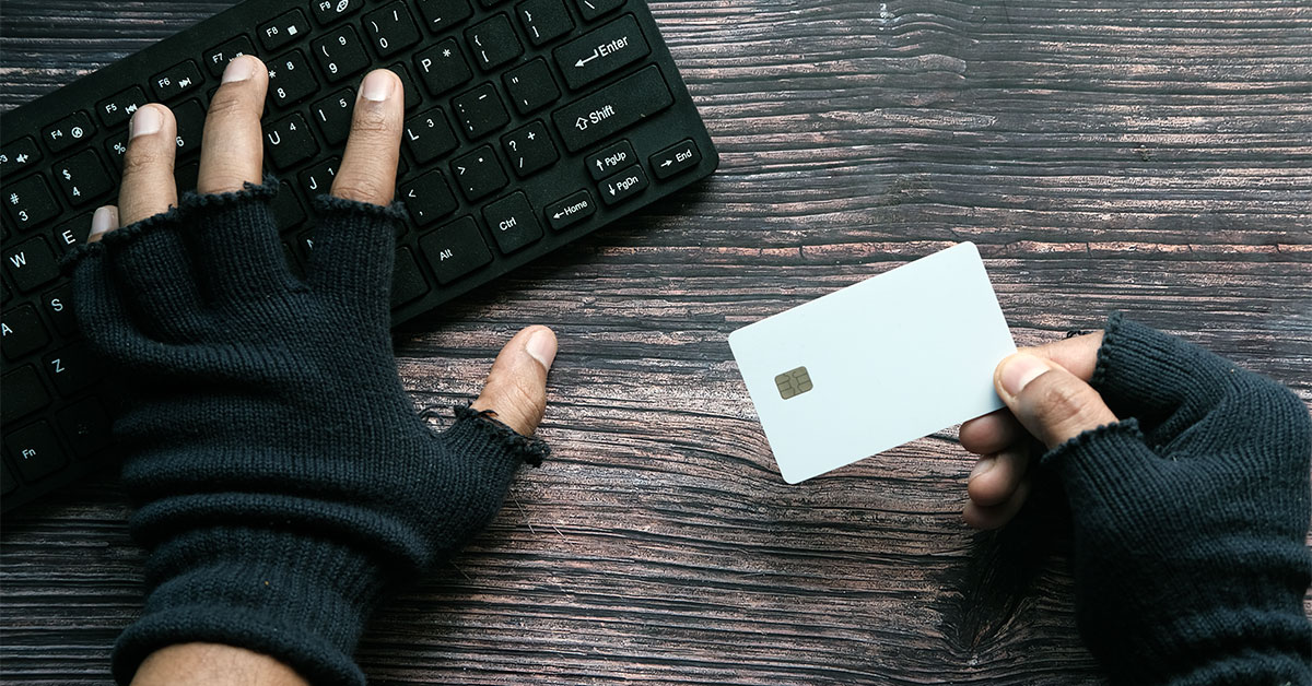 Hacker hand stealing data from credit card