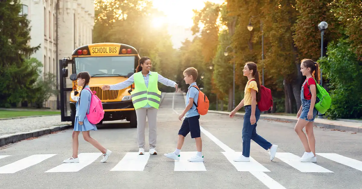 Group of children passing crosswalk on their way to school bus